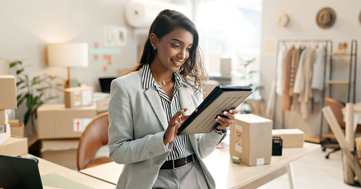 A person at home looking at a tablet to choose insurance coverage for her business